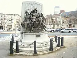 center alt=Three bronze figures