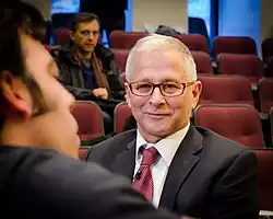 Joseph Arvay smiling and listening to a member of the audience before his conference, on 18 March 2014 in the Maxwell Cohen Moot Court, Chancellor Day Hall, Faculty of Law, McGill University, Montreal, Quebec, Canada.
