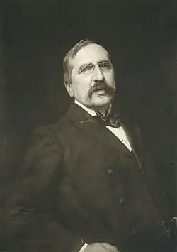a dark sepia photograph of a man with a moustache