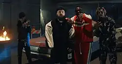 The music video for "Down Like That" places Lil Baby, S-X, Rick Ross and KSI (from left to right) in a dystopian and apocalyptic warehouse, amongst motorcycles, burned out cars, trash can fires and rubble concrete.