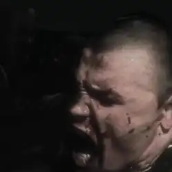 Close-up artwork of a bloodied skinhead