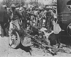 the almost destroyed chassis of Kehoe's Ford pickup truck, surrounded by onlookers