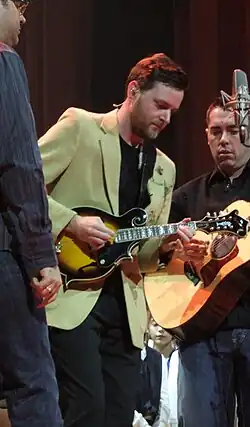 Hearn, in the center, is playing an electric mandolin