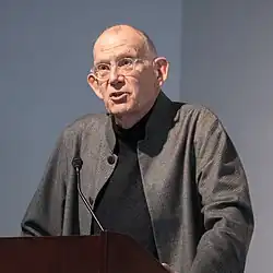 T. M. Scanlon delivering a talk at a lectern.