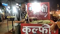 A vendor (kulfiwallah) selling kulfi in India
