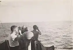 LST-487 crew searching for a Japanese pilot in the water