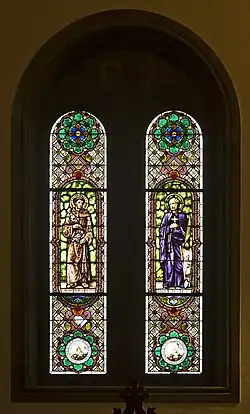 Stained glass windows depicting Saint Diego de Alcalá and Blessed Ignacio de Azevedo