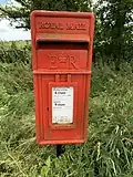 A Queen Elizabeth II Lamp Box post box of the circa-1954 pattern in Eaves, Lancashire