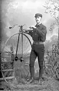 Laurie A. Perkins with a penny-farthing bicycle