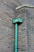 Drain pipe header. Between the letters St. and T is a square to symbolise the apostle as a 'builder.'