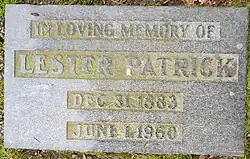 Flat grey granite stone inscribed with his name, birth and death years