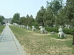 A paved path lined with stone sculptures of animals, as a component of a royal tomb
