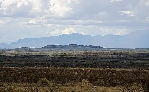 View north to the malpaís lava field and a spatter cone