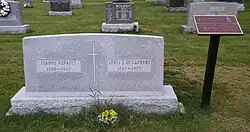Large rectangular grey granite stone inscribed with names, birth years, and death years, of St. Laurent and his wife