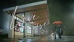 An image of Dennis Trillo and Bea Alonzo standing in the rain. Trillo is holding an umbrella. The series title is displayed on the left side of the image.