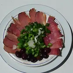 Meat meze with sliced lountza, chiromeri, onions and olives