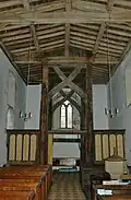 The west end of the nave in St Mary the Virgin parish church, showing the scissor-braced 15th-century frame supporting the bell-turret