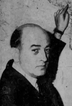 Black and white photo of Munson pointing to Cuba on a map