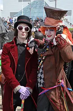 Image 29Two people in costumes inspired by Willy Wonka (from Roald Dahl's Charlie and the Chocolate Factory), and the Hatter (from Lewis Carroll's Alice's Adventures in Wonderland) in London (from Children's literature)