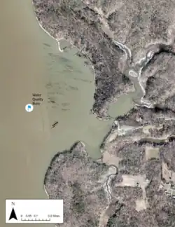 Overhead photo of Mallows Bay indicating the location of a buoy moored in 2018 that monitors water quality. Shipwrecks also are visible.
