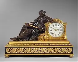 French Neoclassical mantel clock (pendule de cheminée); 1757–1760; gilded and patinated bronze, oak veneered with ebony, white enamel with black numerals, and other materials; 48.3 × 69.9 × 27.9&nbsp;cm; Metropolitan Museum of Art