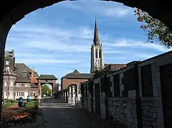 Southern part of the courtyard seen from the porch, with the Our Lady of Mercy church in the background, and the De Cartier metro station entrance on the right.