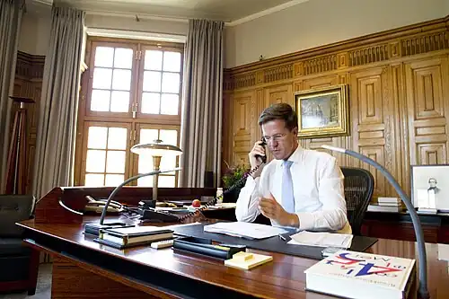 Interior Mark Rutte at his desk in 2012
