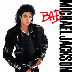 A man in his late twenties stands and looks forward. His hair is curly and black. He is wearing a black jacket that has several buckles and pants. The background is white and beside him are the words "Michael Jackson" in black capital letters, and over them, "Bad" in red.