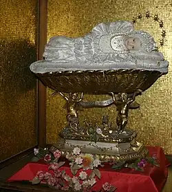 Wax statuette, in the fashion of the 19th century, of Holy Child Mary, Left transept.