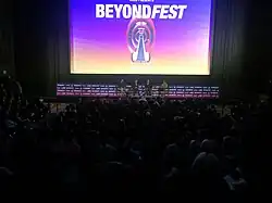 The comedians seated in directors chairs