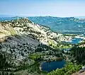 South aspect of Mount Millicent rises above Lake Catherine, Lake Martha and Lake Mary as viewed from Sunset Peak