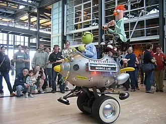 The Muppet Mobile Lab, featuring Bunsen and Beaker, during a visit to Pixar in 2007. Pixar's chief creative officer Pete Docter can be seen above the vehicle's headlights.