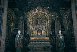 Jin Dynasty (1115–1234) statue of Vairocana in Shanhua Temple in Datong, Shanxi, China, one out of a set of statues of the Five Tathāgatas.