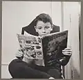 New York, N.Y. Children's Colony, German refugee child, reading a Superman comic book