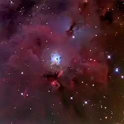 The reflection nebula NGC&nbsp;1999 (blue cloud in the center) and the Herbig-Haro Objects HH&nbsp;1/2 below NGC 1999 as small pink clouds.
