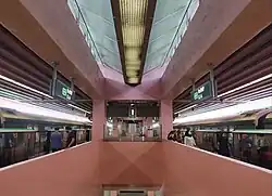 A photograph of Redhill's platforms, which features its pink walls and the clerestory windows of its roof