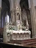 Richly decorated altar and choir organ with painted pipes