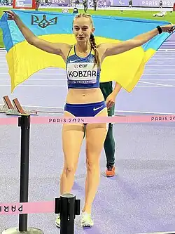 Photograph of Kobzar holding the Ukrainian flag