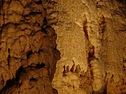 Water on calcite shimmers in the cave's lighting