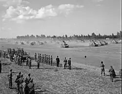 Small photo of tanks kicking up clouds of dust