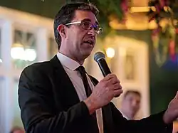 Goiran speaking into a microphone