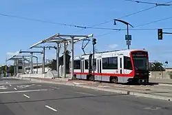 A light rail train crossing a concrete bridge