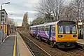 A Northern Rail Class 142 waits at the station.