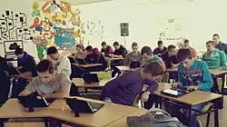 Students learning how to edit a Wikipedia article on a tablet computer