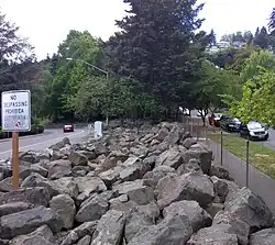 Boulders installed along a freeway ramp in Portland, Oregon, United States as a hostile architecture to deter transient camps