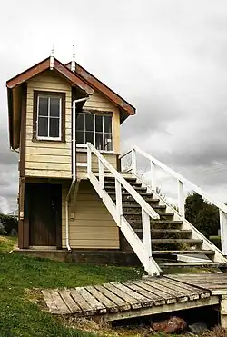 photo of a small two-storey wooden building