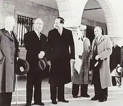 A photograph of the opening of the new National Bank of Liechtenstein building in 1953. Standing from the left are Josef Ospelt, Josef Hoop, Franz Joseph II, David Strub, and Alexander Frick.