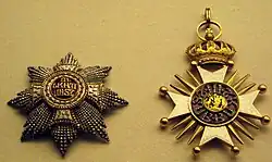 Two jeweled star-burst medallions. One is heavily crusted with carved gold and small gold beads; the other has carved gold, with a central jewel.