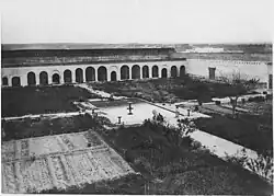 Another view of the menagerie courtyard, looking southwest; the arches along the far wall held cages for lions or other animals (photo from 1913)[11]