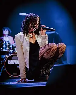 The image depicts Heather Baron-Gracie performing on stage